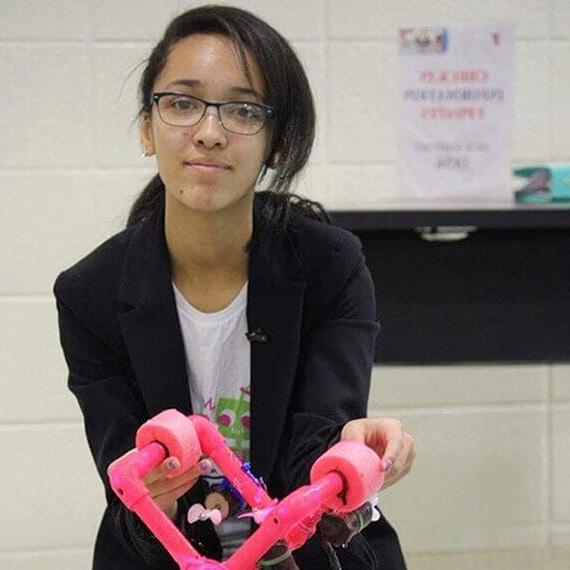 Image of Madison holding a robot she built